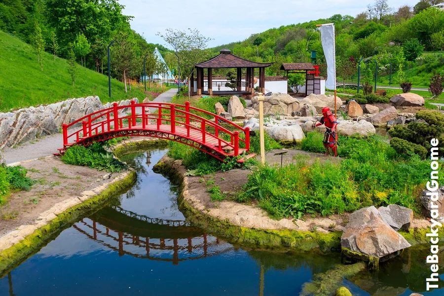 Red bridge and gazebo by a pond in Japanese garden - Part 1